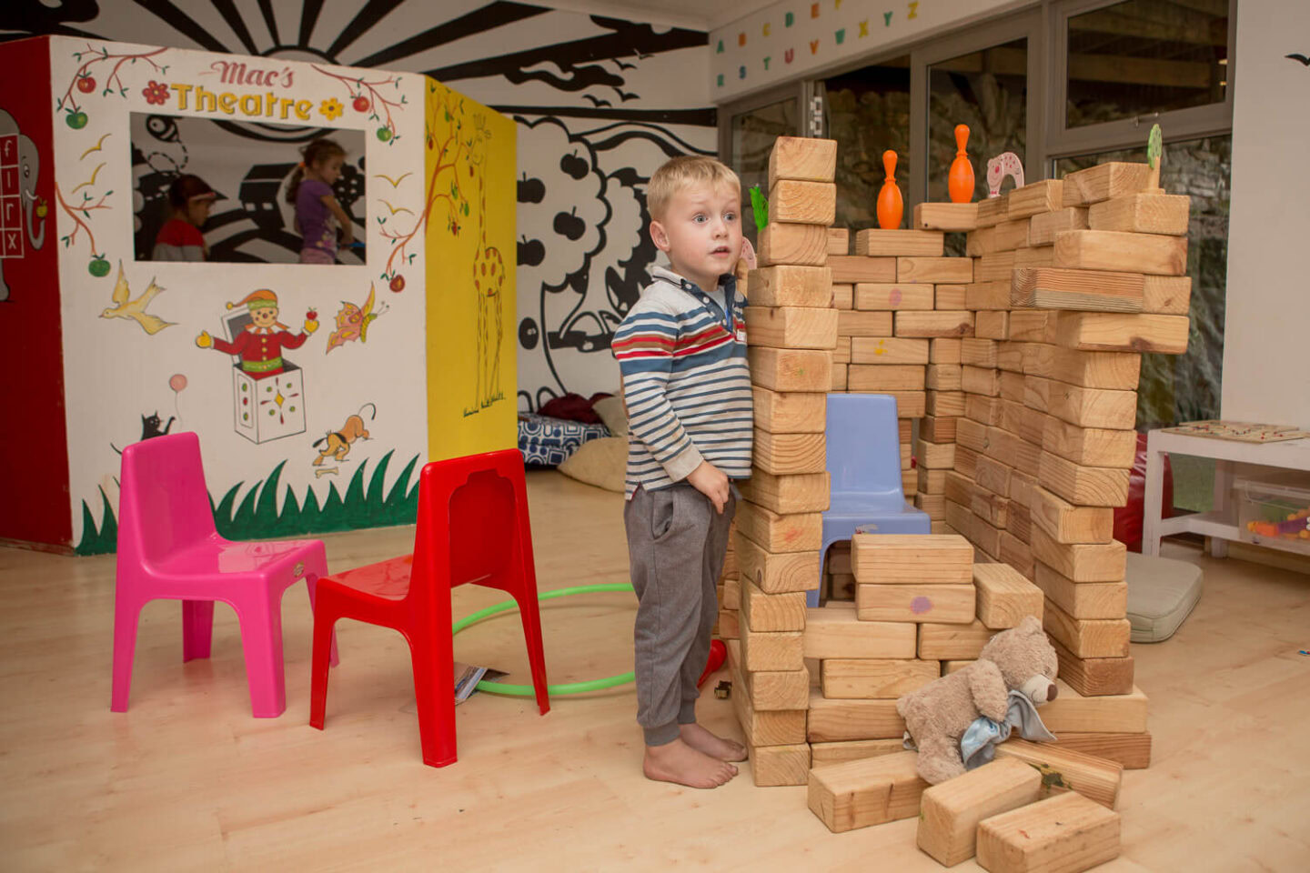 Activities A little boy building with wooden blocks in the kids' playroom, Old Mac Daddy, Elgin Valley
