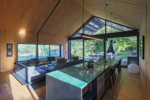 Apple Grove: open-plan living room and green-stone kitchen island under the glass gable, Old Mac Daddy, Elgin Valley