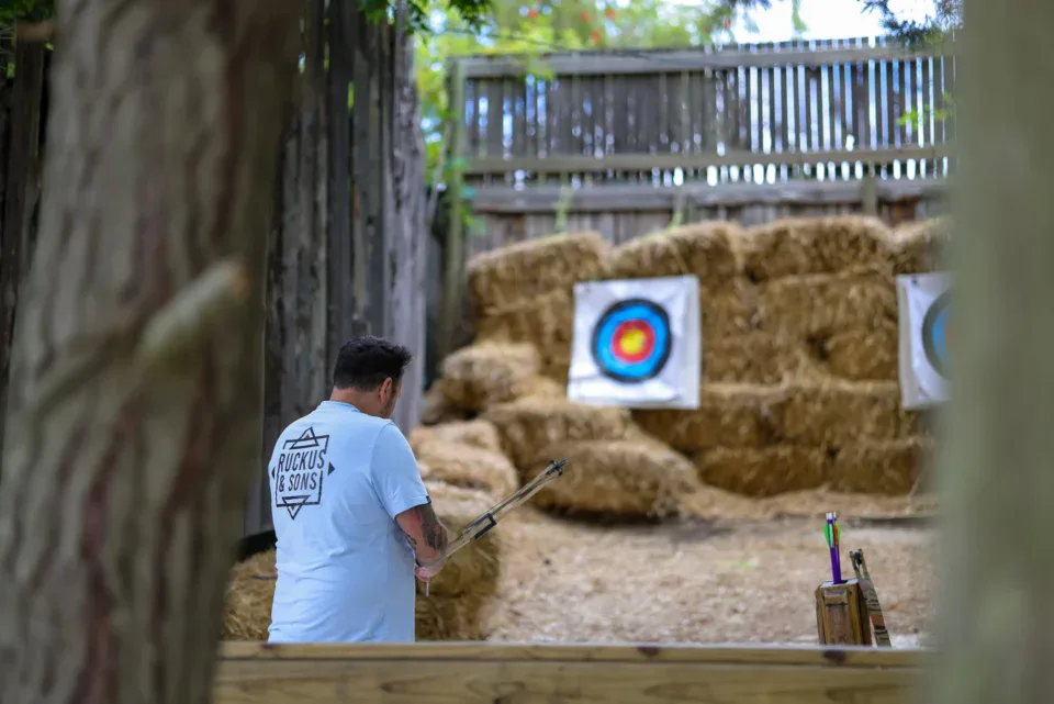 Archer lining up a shot at targets on hay bales, Old Mac Daddy, Elgin Valley