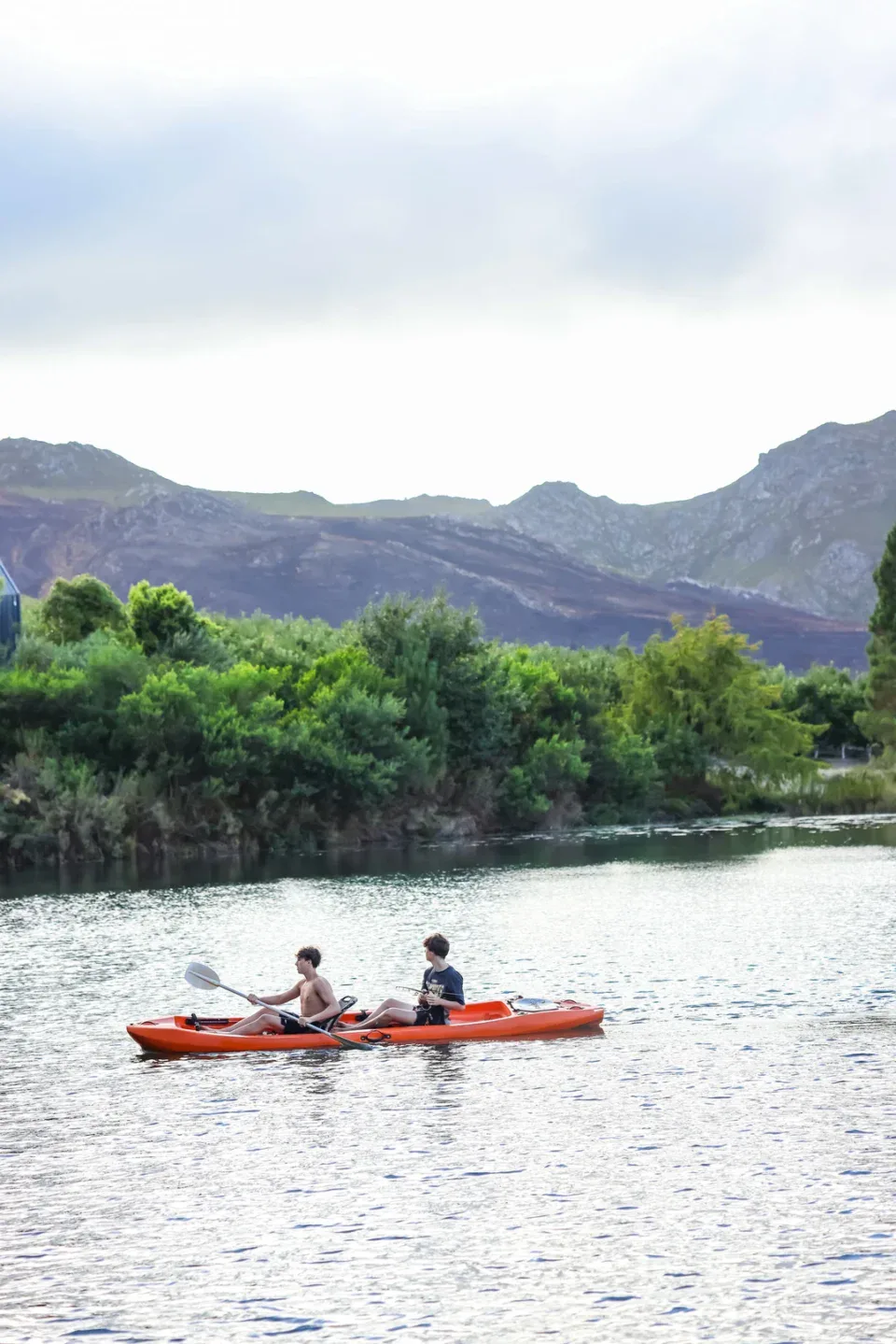 Two adults kayaking, mountains behind, Old Mac Daddy, Elgin Valley