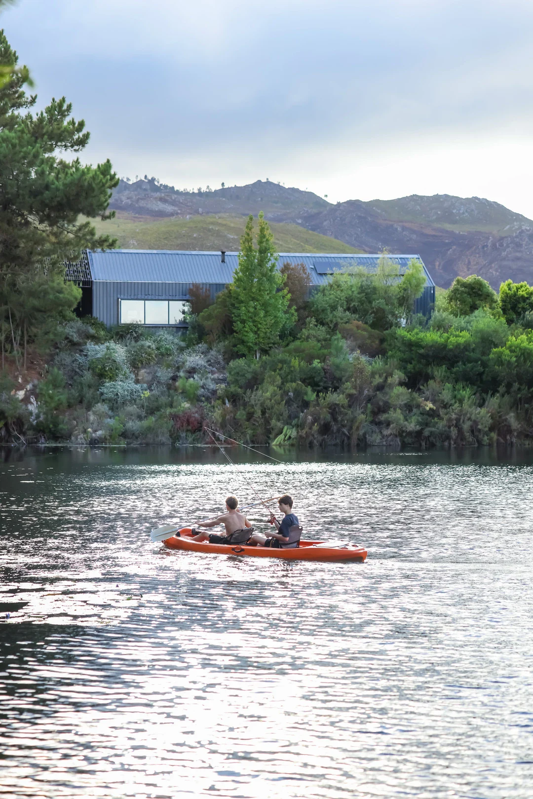 Adults kayaking with the lodge on the shore, Old Mac Daddy, Elgin Valley