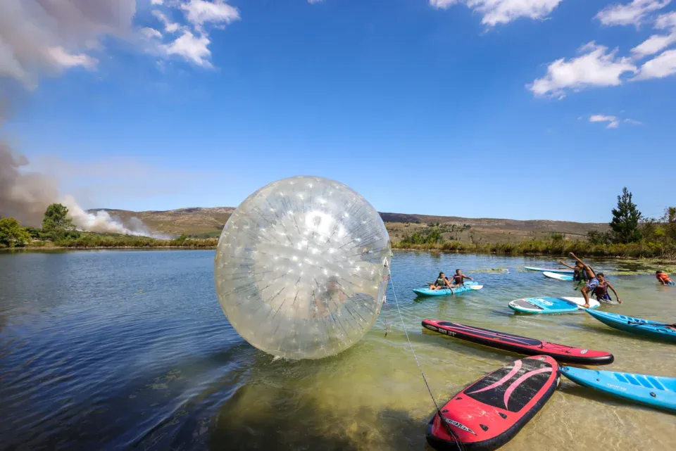 Water zorb on the lake beside paddle boards and kayakers, Old Mac Daddy, Elgin Valley