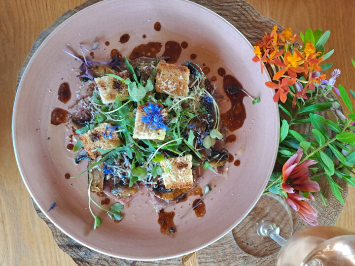 A salad with toasted cubes, microgreens and a dark sauce, Old Mac Daddy, Elgin Valley