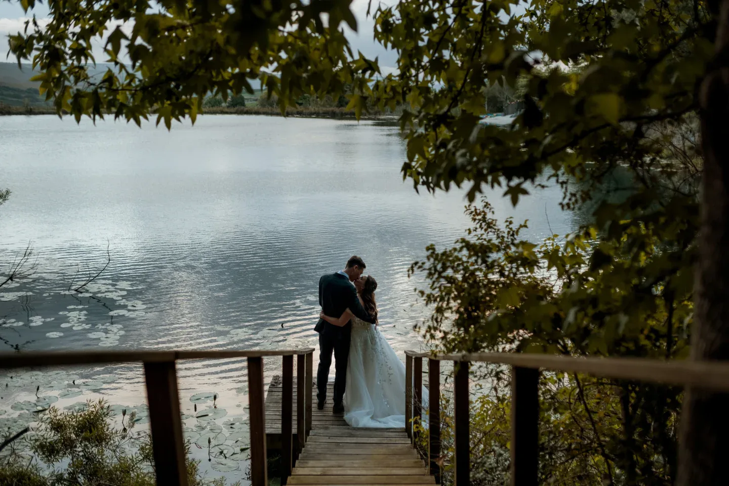 Weddings & Events (new) Couple embracing on the jetty, lake and hills behind, Old Mac Daddy, Elgin Valley