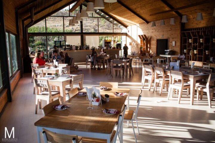 The Barn restaurant in afternoon light, with set tables under a high timber roof, Old Mac Daddy, Elgin Valley