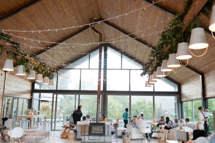 Guests relaxing in the Barn lounge set-up under festoon lights and greenery, Old Mac Daddy, Elgin Valley